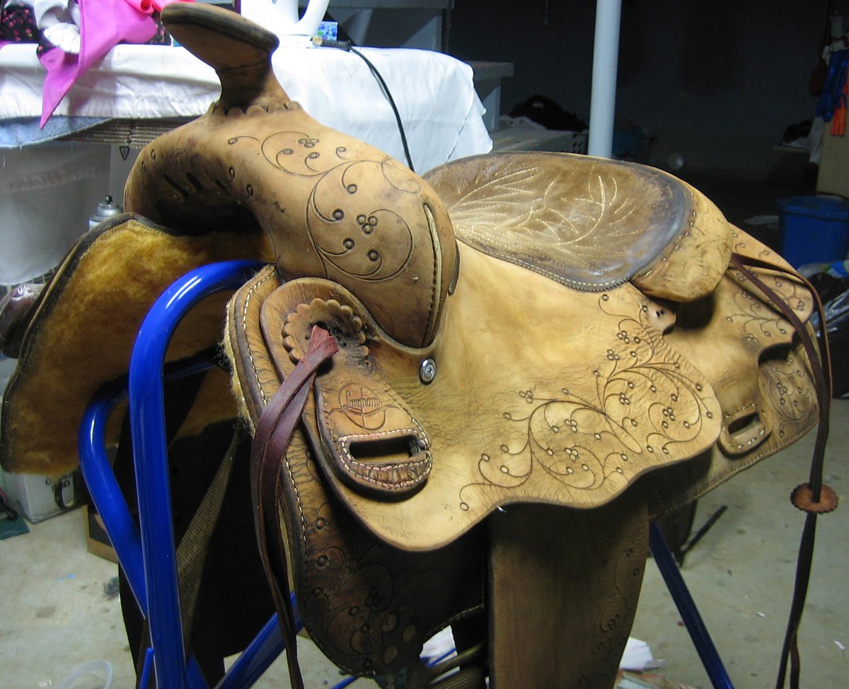 western saddle with brand markings.