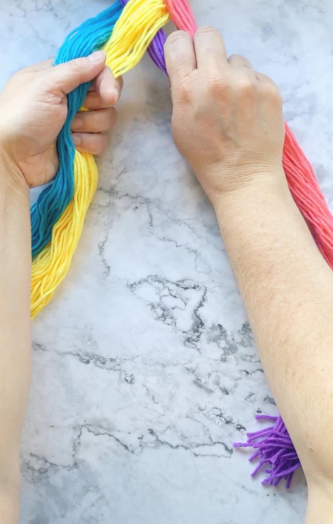 hands braiding a four strand braid